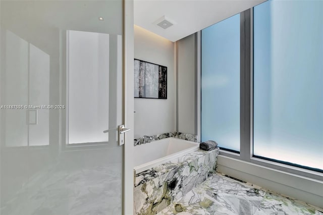 bathroom with tiled tub