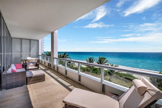 balcony featuring a water view and a view of the beach