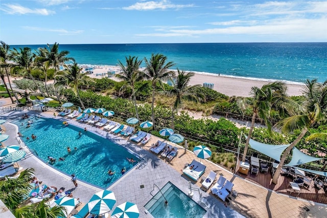 birds eye view of property with a water view and a view of the beach