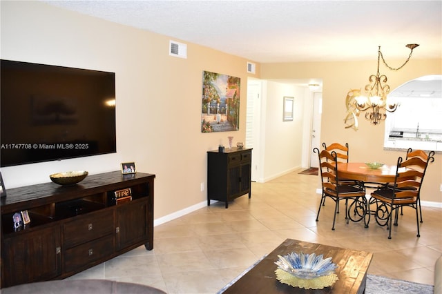 dining room with a chandelier, visible vents, and baseboards