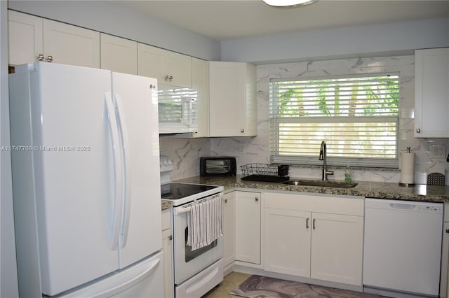 kitchen featuring white appliances, a sink, and white cabinets