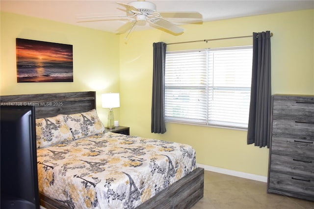 bedroom featuring ceiling fan, baseboards, and tile patterned flooring