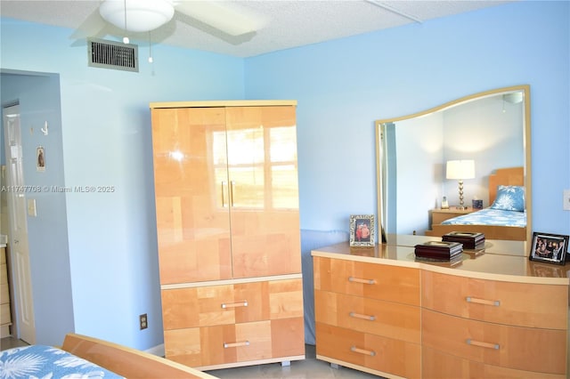 bedroom with a textured ceiling and visible vents