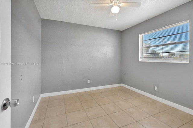 empty room with ceiling fan and a textured ceiling