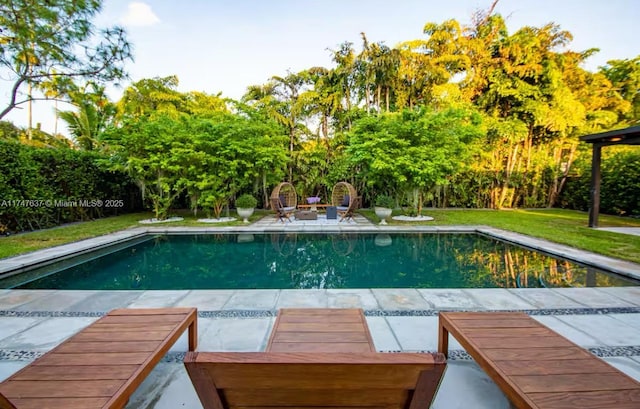 view of pool featuring a lawn