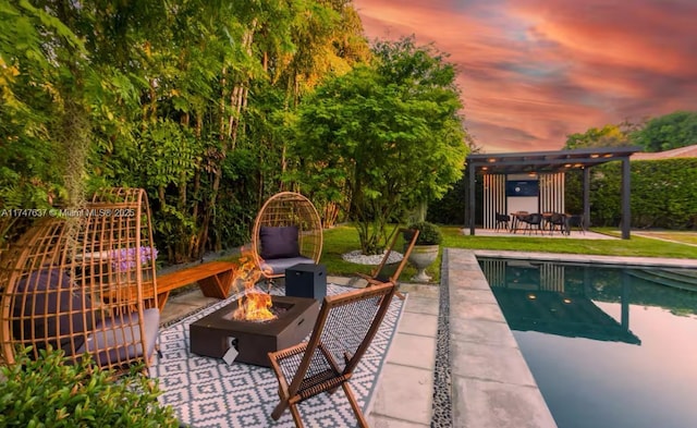 exterior space featuring a patio, a pergola, and a fire pit