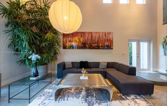 interior space with french doors and a towering ceiling