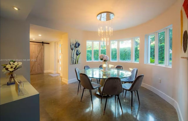 dining area with a barn door and a notable chandelier