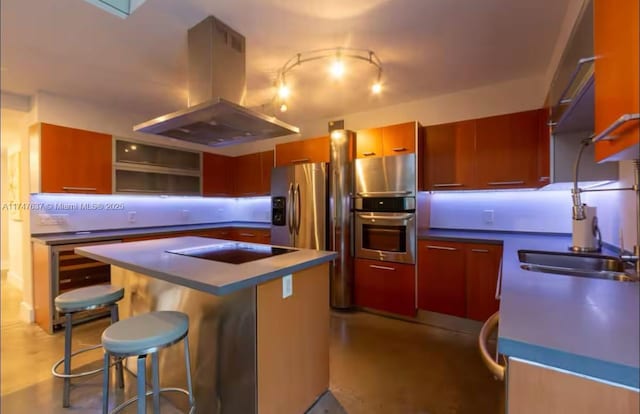 kitchen with a breakfast bar, a center island, island range hood, stainless steel double oven, and black electric cooktop