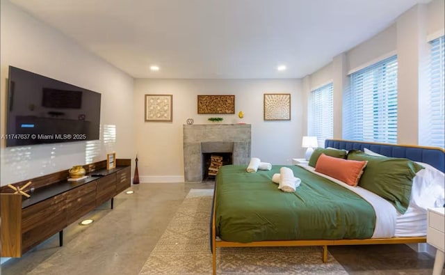 bedroom featuring a tiled fireplace