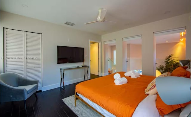 bedroom with a closet, ceiling fan, and dark hardwood / wood-style floors