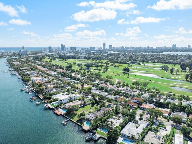 drone / aerial view featuring a view of city and a water view