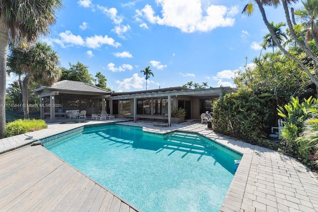 outdoor pool with a gazebo and a patio area