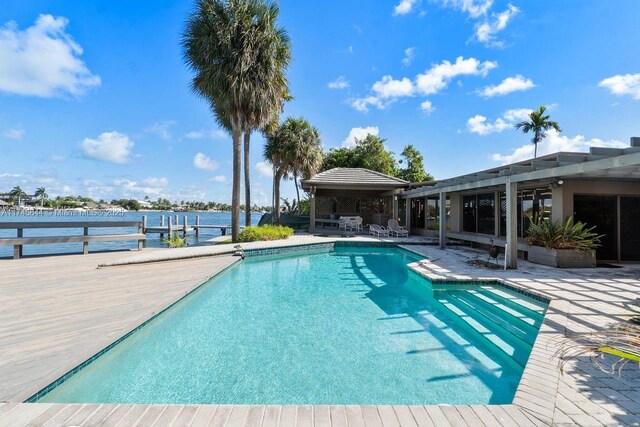 outdoor pool featuring a water view, a patio area, a pergola, and a gazebo