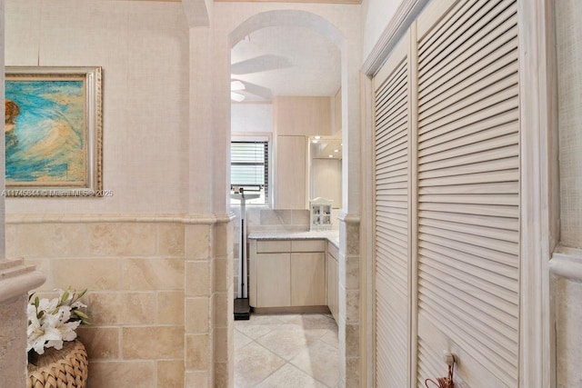 interior space featuring a closet, tile patterned flooring, and tile walls