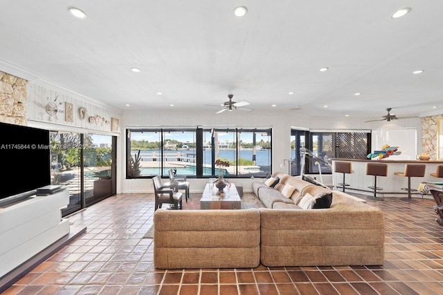 living area featuring ornamental molding, plenty of natural light, and recessed lighting