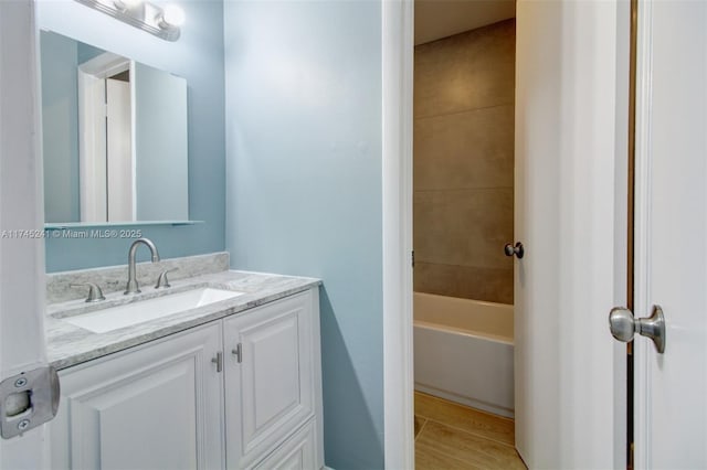 bathroom with vanity and a washtub