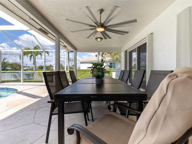 view of patio / terrace with ceiling fan and glass enclosure