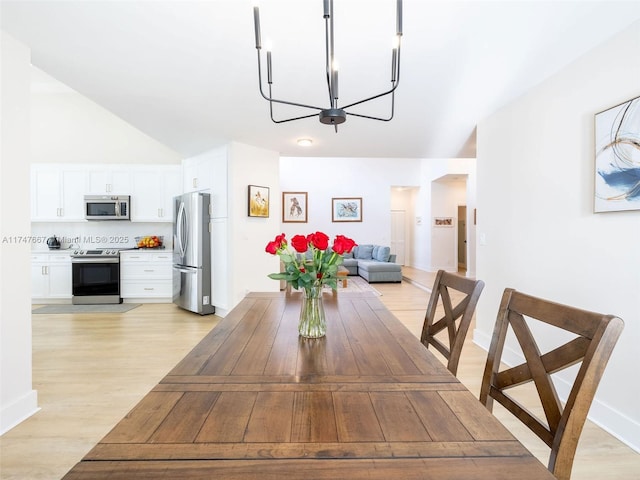 unfurnished dining area featuring light wood-type flooring and an inviting chandelier