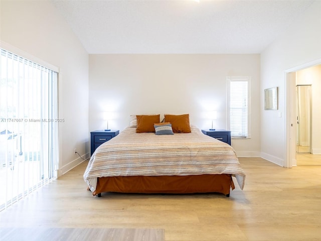 bedroom with light wood-type flooring and access to exterior