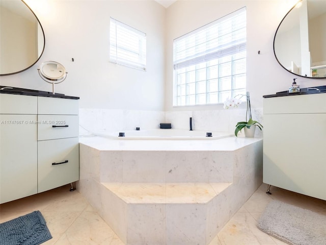 bathroom featuring vanity and a relaxing tiled tub