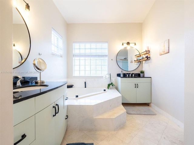 bathroom featuring vanity and tiled tub