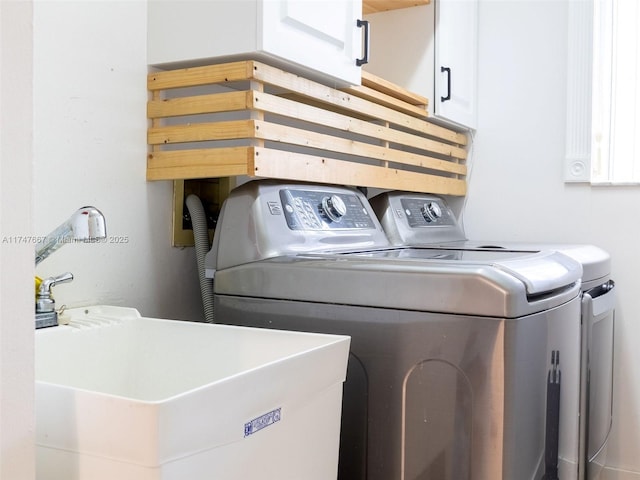 laundry room with sink, cabinets, and separate washer and dryer