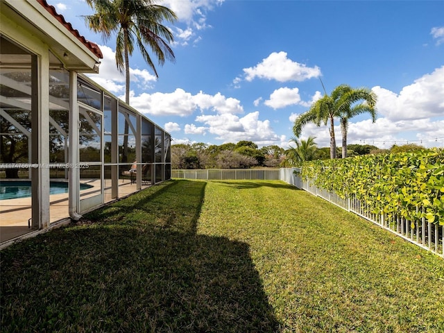 view of yard featuring glass enclosure and a fenced in pool