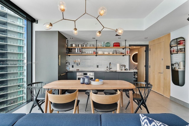 tiled dining room featuring sink