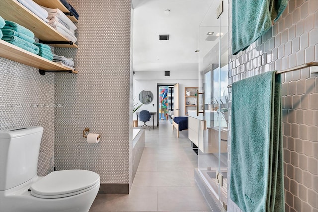 bathroom with toilet and tile patterned floors