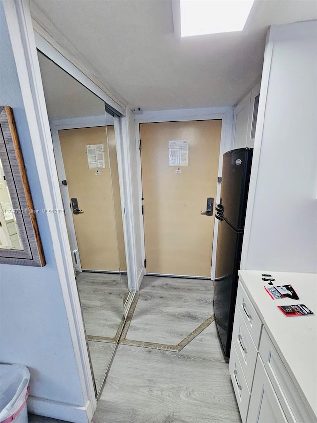 corridor featuring light hardwood / wood-style floors