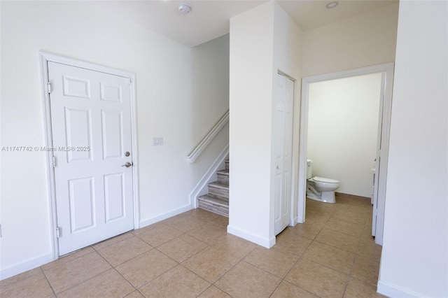 stairway with tile patterned flooring and baseboards