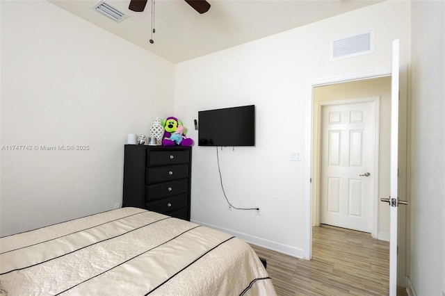 bedroom with baseboards, visible vents, and light wood-style floors