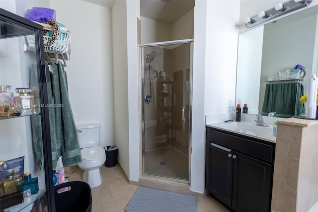 full bath with toilet, tile patterned floors, a shower stall, and vanity