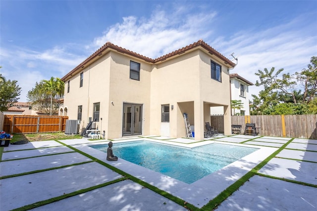 view of pool featuring a patio area, a fenced backyard, central AC unit, and a fenced in pool