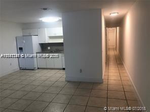 kitchen with tile patterned floors, white cabinets, and fridge with ice dispenser