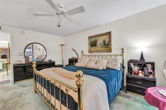 carpeted bedroom with a textured ceiling and ceiling fan