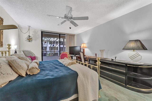 bedroom featuring ceiling fan, carpet flooring, access to exterior, and a textured ceiling