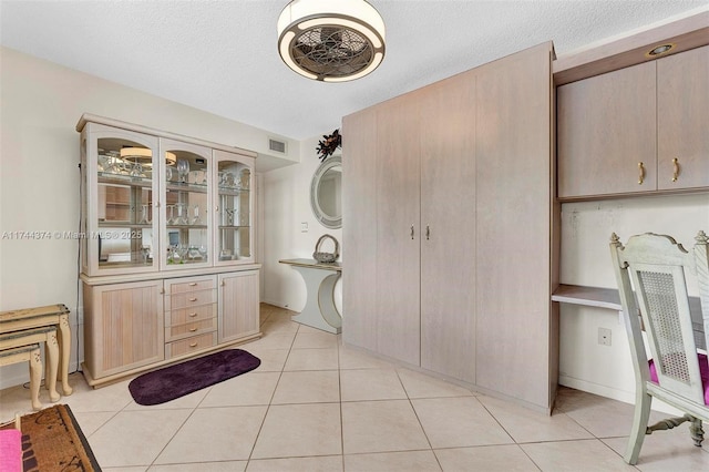 bathroom featuring tile patterned floors and a textured ceiling