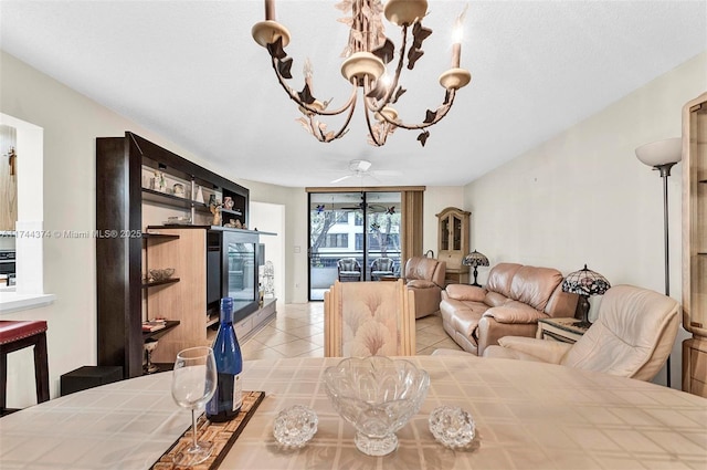 dining area featuring light tile patterned flooring and a chandelier