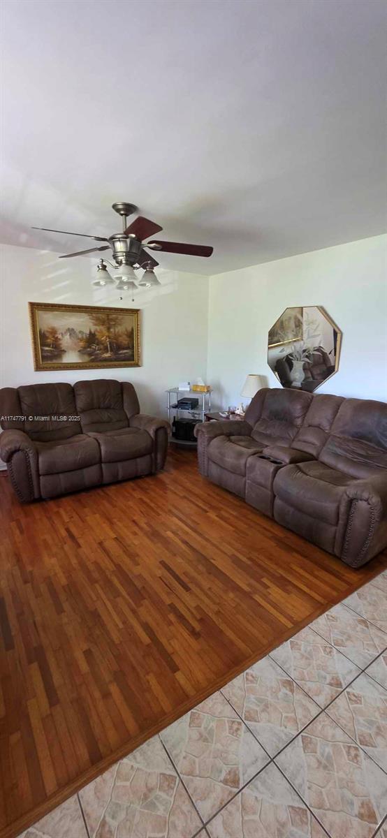 living room with ceiling fan and light wood-type flooring