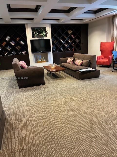 home theater room featuring coffered ceiling, carpet flooring, and beam ceiling