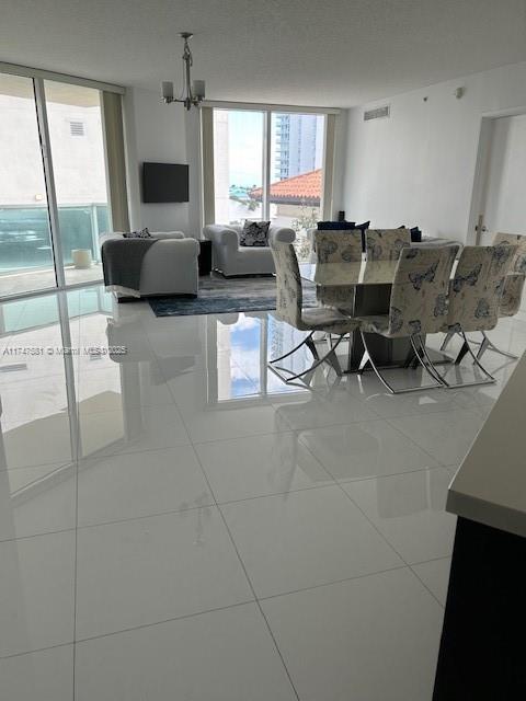 living room with tile patterned flooring and expansive windows