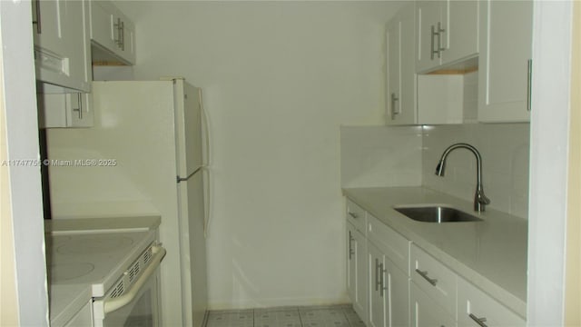 kitchen featuring decorative backsplash, sink, white cabinetry, and electric range oven