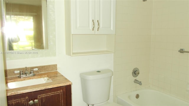 full bathroom with tiled shower / bath combo, vanity, and toilet