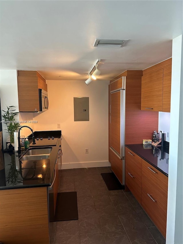 50 Biscayne Blvd Unit 3505, Miami, FL 33132 - kitchen featuring brown cabinets, a sink, electric panel, and dark countertops
