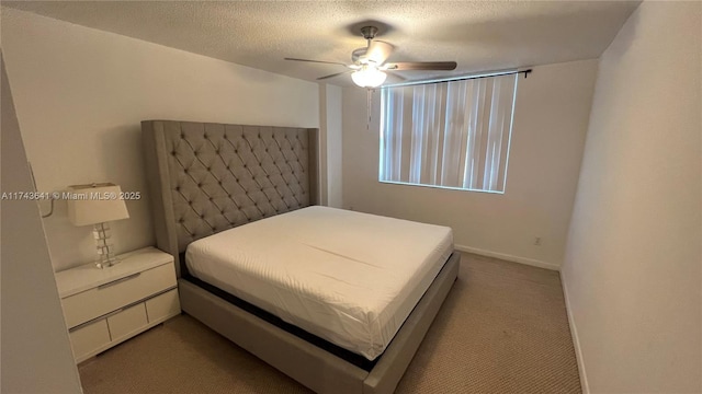 bedroom featuring a textured ceiling, baseboards, a ceiling fan, and carpet