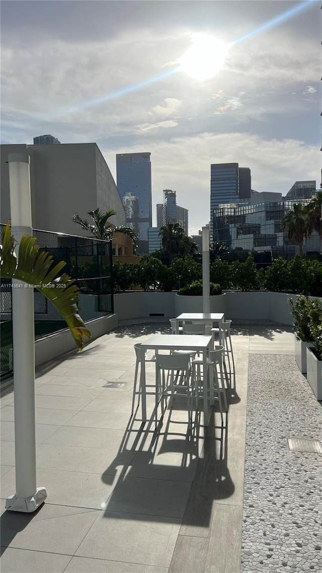 view of patio / terrace with a view of city and outdoor dining area