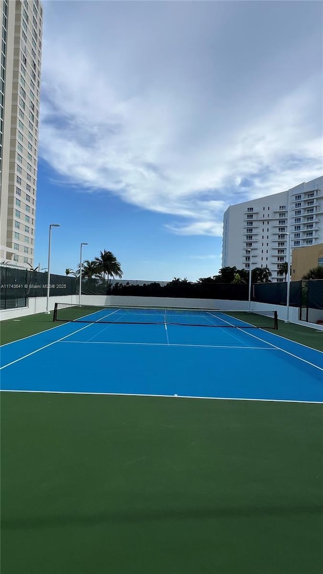 view of sport court featuring fence