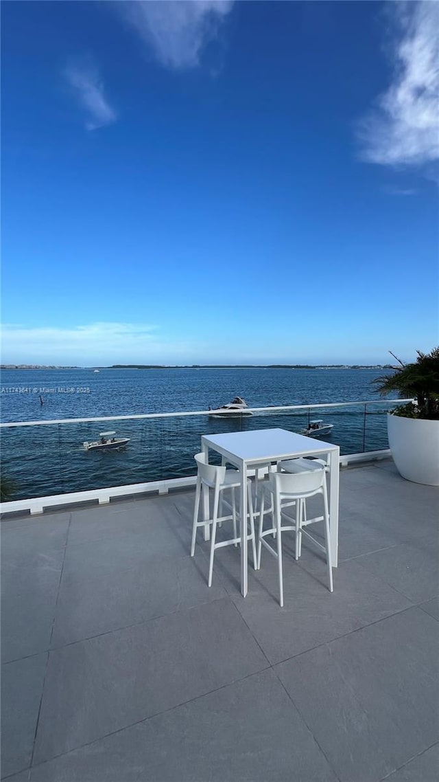 view of patio / terrace featuring a water view and outdoor dining area